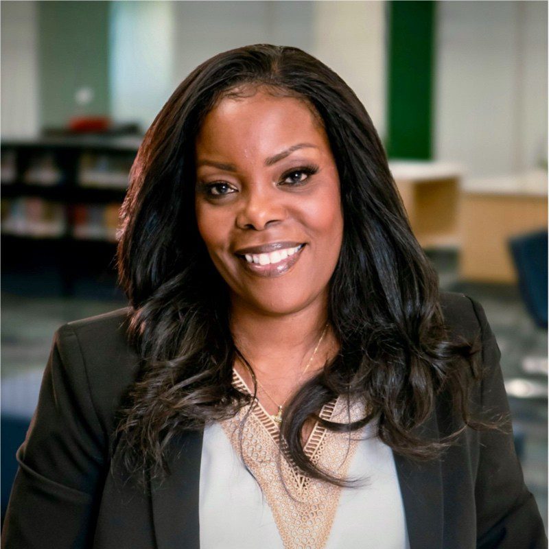 Smiling professional woman in an office setting.